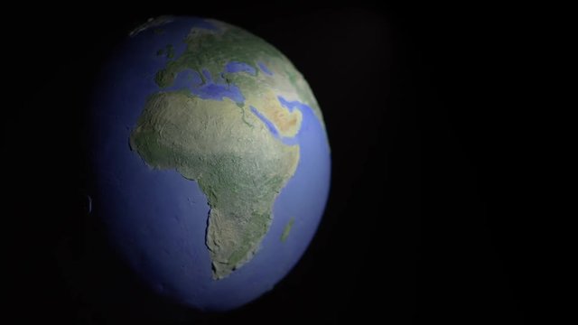 Half-lit off-center seamless loop of globe