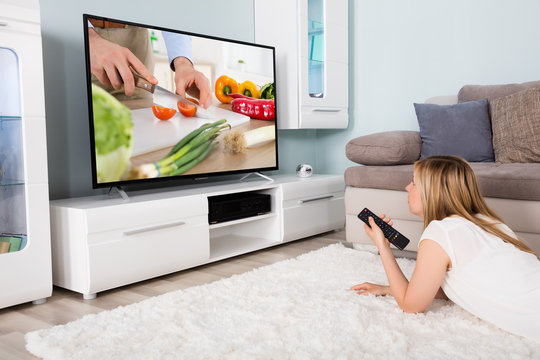 Woman Watching Cooking Show On Television