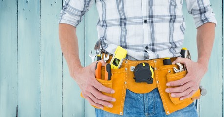 Fototapeta na wymiar Handyman with tool belt at home