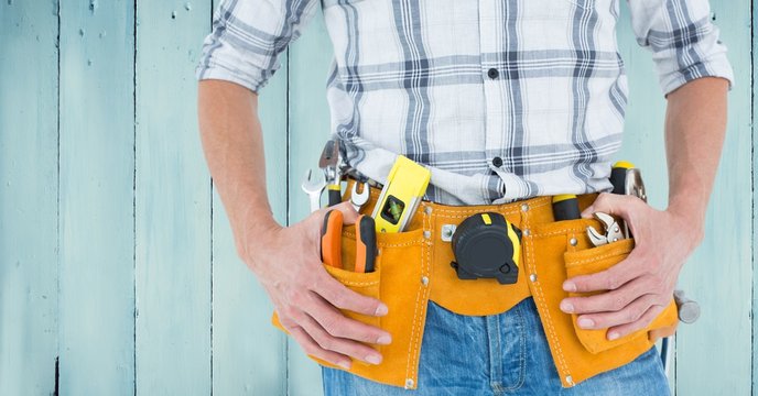 Handyman with tool belt at home