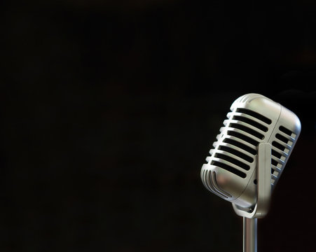 Vintage microphone with blurred black background and soft focus