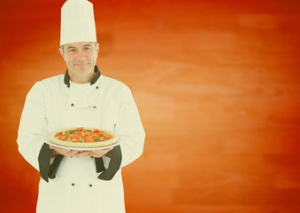 Smiling male chef presenting food in kitchen
