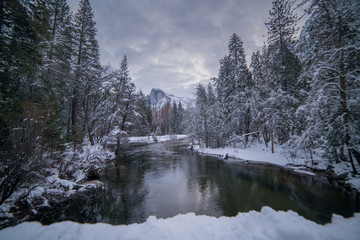Half Dome reflected in Merced River near Sentinel Bridge after a winter snow storm