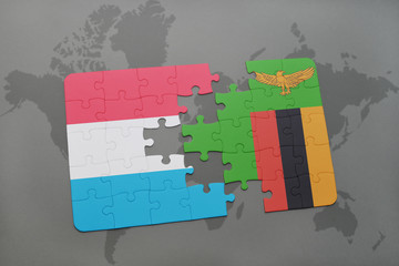 puzzle with the national flag of luxembourg and zambia on a world map