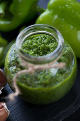 Close-up of a glass jar with freshly made chimmichurri sauce