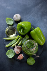 Chimmichurri with its ingredients on a grey metal background