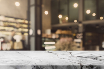 Stone table top and blurred bokeh cafe and coffee shop interior