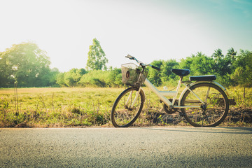 Bicycle at road side with field background 