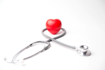 Medical stethoscope and heart isolated on white