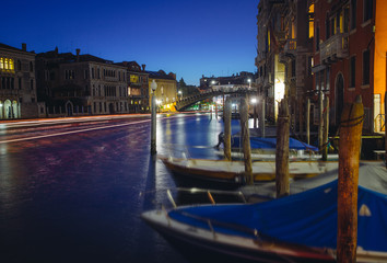 Grand canal in Venice during night with parked boats