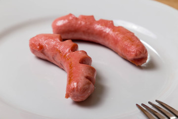 grilled sausages on fork an plate useful for background