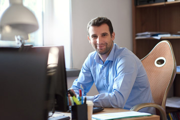Smiling businessman at work in an office