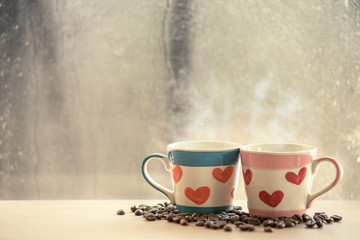 two lovely glass with coffee bean on rainy day window background
