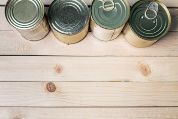 Tin cans for food on wooden background