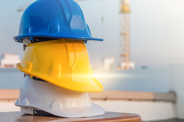 The safety helmet at construction site with crane background