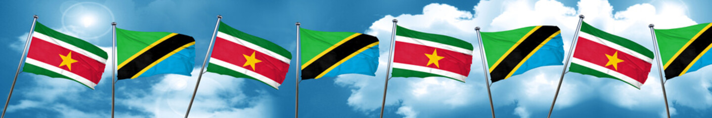 Suriname flag with Tanzania flag, 3D rendering