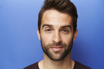 Handsome dude on blue background, portrait
