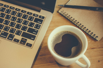 Laptop with cup of fresh coffee