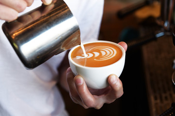 Fototapeta na wymiar cup of latte art coffee for background