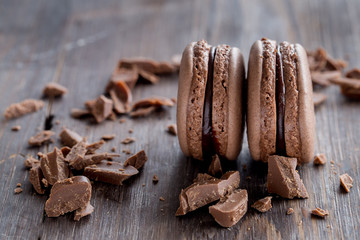 Chocolate macarons on a rustic wooden table