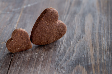 Valentine's chocolate heart cookies on black wooden old background