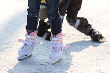 Close-up of ice skating shoes on a rink
