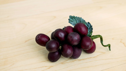 Grapes with leaf on wood background
