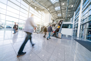blurred business people at a trade fair stock photo