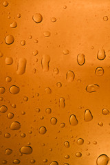 Fresh background of water drops on orange surface
