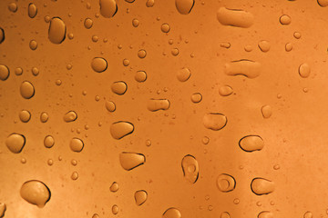 Fresh background of water drops on orange surface
