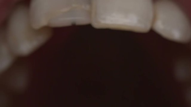 Extreme closeup shot of a mouth talking