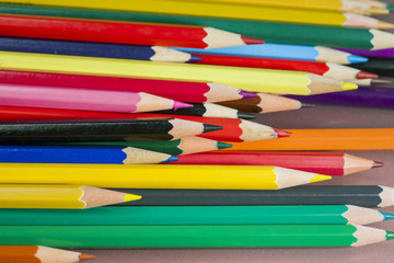 Group of colored pencils with white background and reflexions
