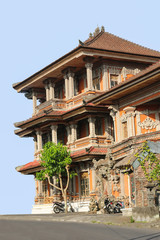 traditional Balinese multi-storey house with balconies and carved elements