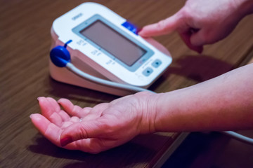 Woman is taking care for health with hearth beat monitor and blood pressure