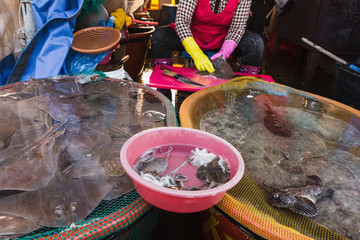 woman sells seafood on the Asian market © scharfsinn86