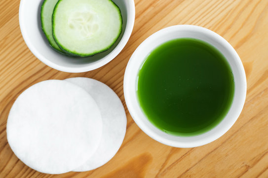 Cucumber juice in a small ceramic bowl for preparing natural facial toner. Homemade cosmetics.
