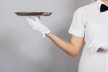 Woman waitress with a tray in the hand