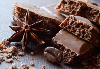 Black aerated chocolate in bars with anise and coffee beans,food