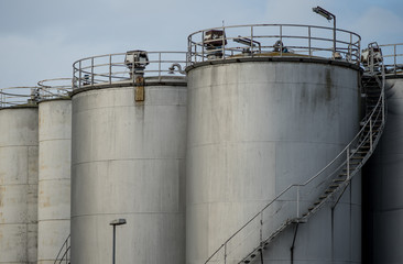 Industrial silos against the grey sky