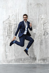 Jumping for joy man in blue suit