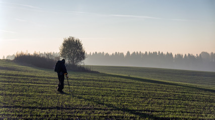 Man holds demining on the field.