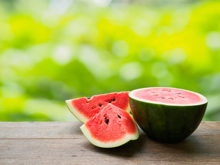 Fresh watermelon slice on wooden table of natural background © dokmaihaeng