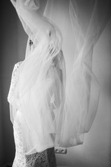 Veil flies around bride looking through it
