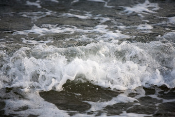Wave and sand closeup
