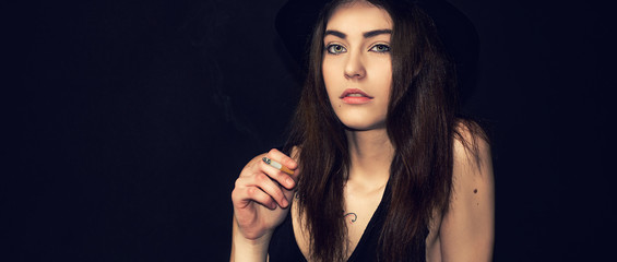 Pretty girl portrait with gorgeous eyes smoking cigarette letterbox