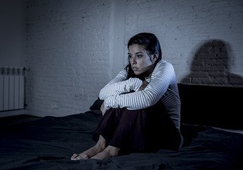 hispanic woman at home bedroom lying in bed late at night trying to sleep suffering insomnia