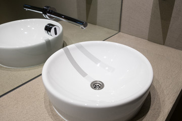Contemporary European white sink, Ceramic sink with contactless sensor,  Public toilet with modern wash basins detail, Symbol of modern cleansing, Design sinks in bathroom