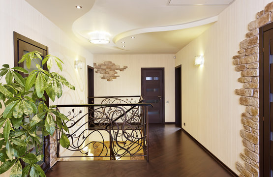 Classical stairs with ornamental handrail in hallway with doors