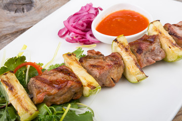 Fried meat on a metal skewer