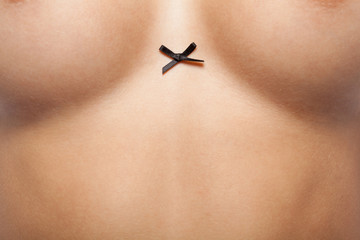 Fototapeta premium Woman breast with little black bow.